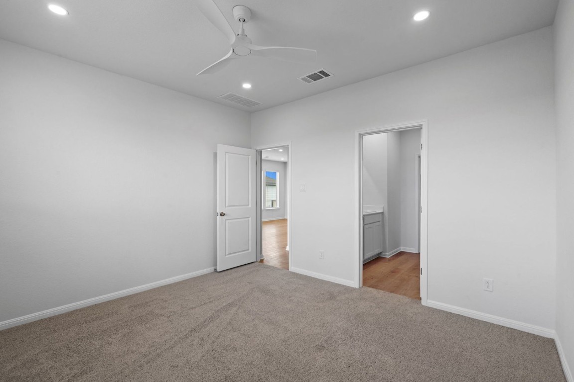 145 Hatari Trail Jarrell, TX 76537 - Photo 12 of 37 an empty room with an entryway and fan