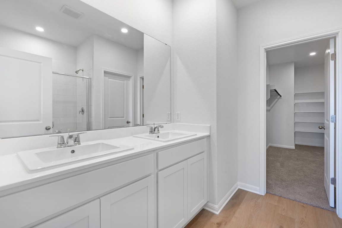 145 Hatari Trail Jarrell, TX 76537 - Photo 13 of 37 a bathroom with a sink and a mirror