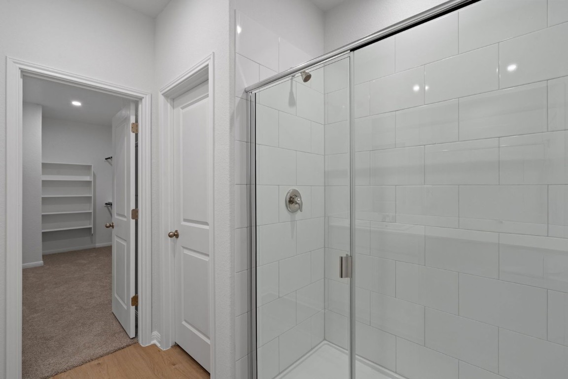 145 Hatari Trail Jarrell, TX 76537 - Photo 15 of 37 a bathroom with a shower and a glass door