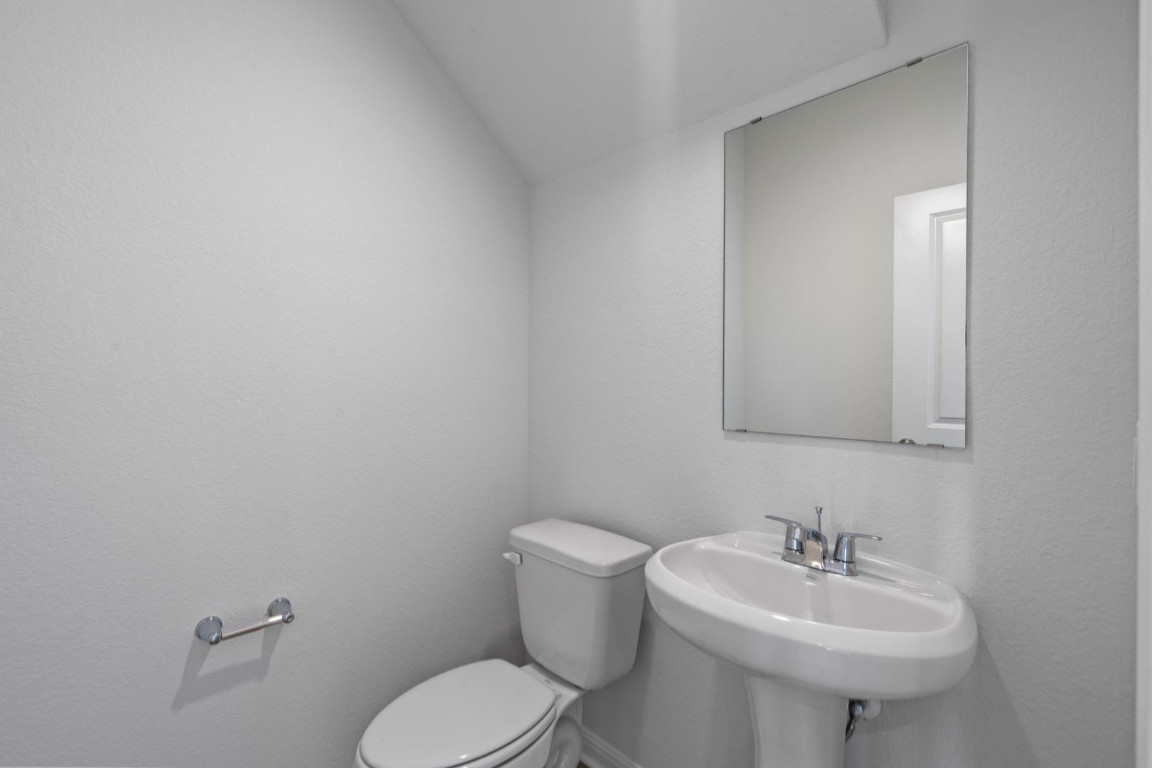 145 Hatari Trail Jarrell, TX 76537 - Photo 17 of 37 a bathroom with a sink a toilet and mirror