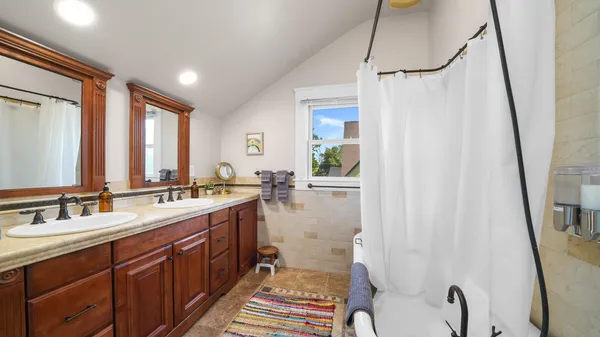 a bathroom with a granite countertop sink mirror vanity and toilet