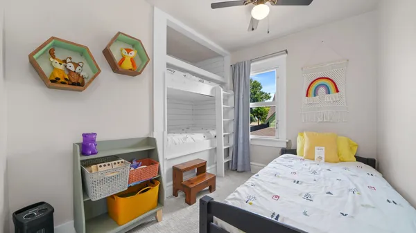 a bedroom with a bed and a chandelier