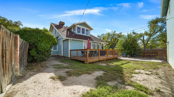 a view of a house with backyard porch and sitting area