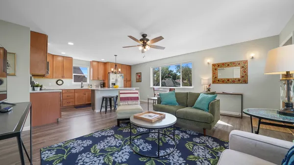 a kitchen with a refrigerator a sink cabinets and wooden floor