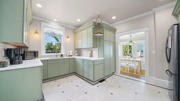 a kitchen with stainless steel appliances granite countertop a stove a sink and a refrigerator