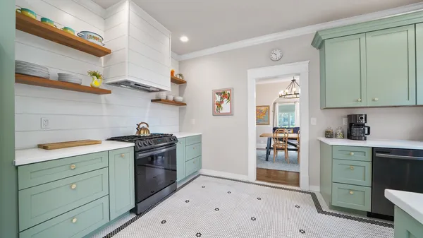 a kitchen that has a sink and a stove in it