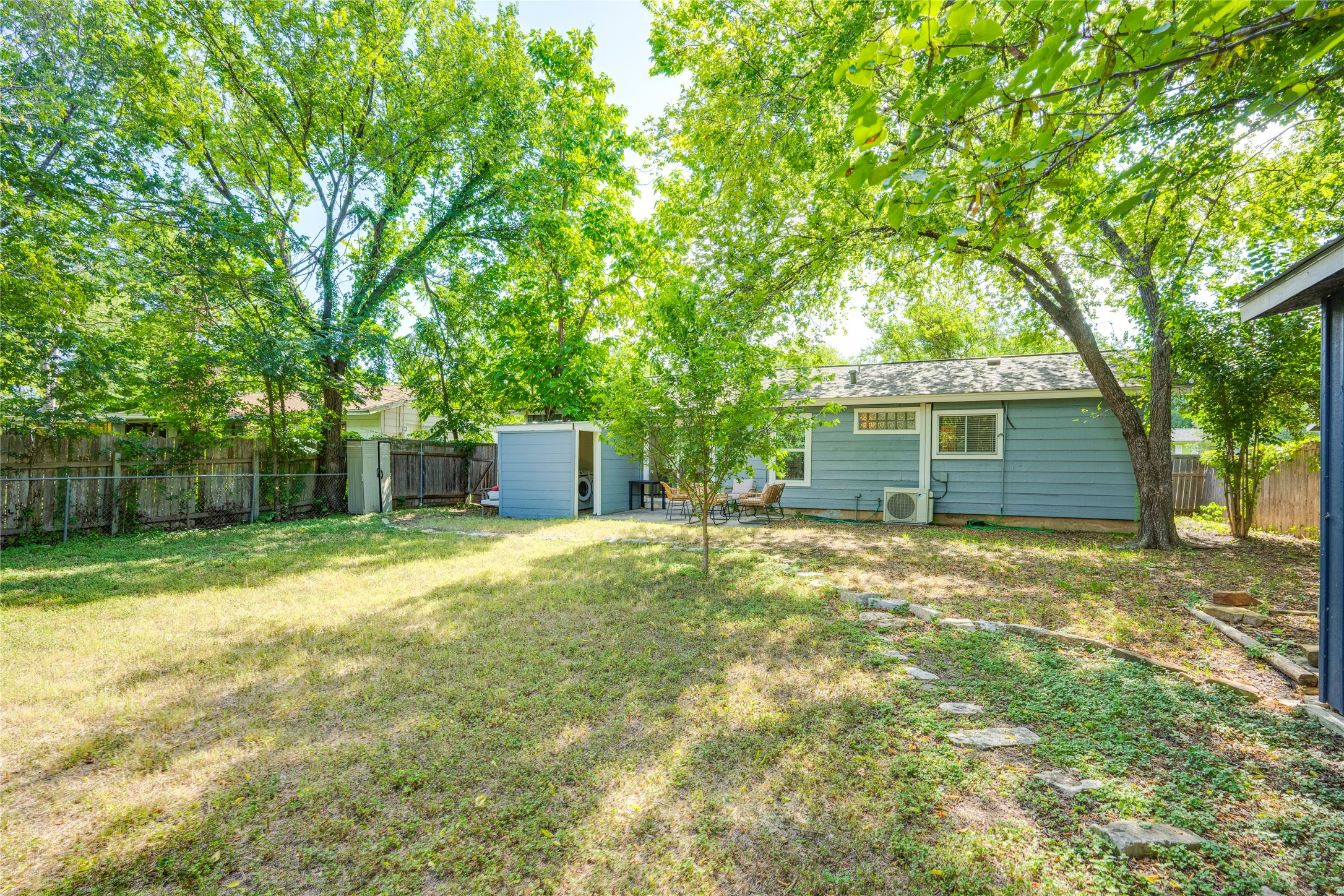5300 Halmark Drive Austin, TX 78723 - Photo 28 of 40 A verdant backyard offers a private retreat with ample green space and a convenient storage shed.