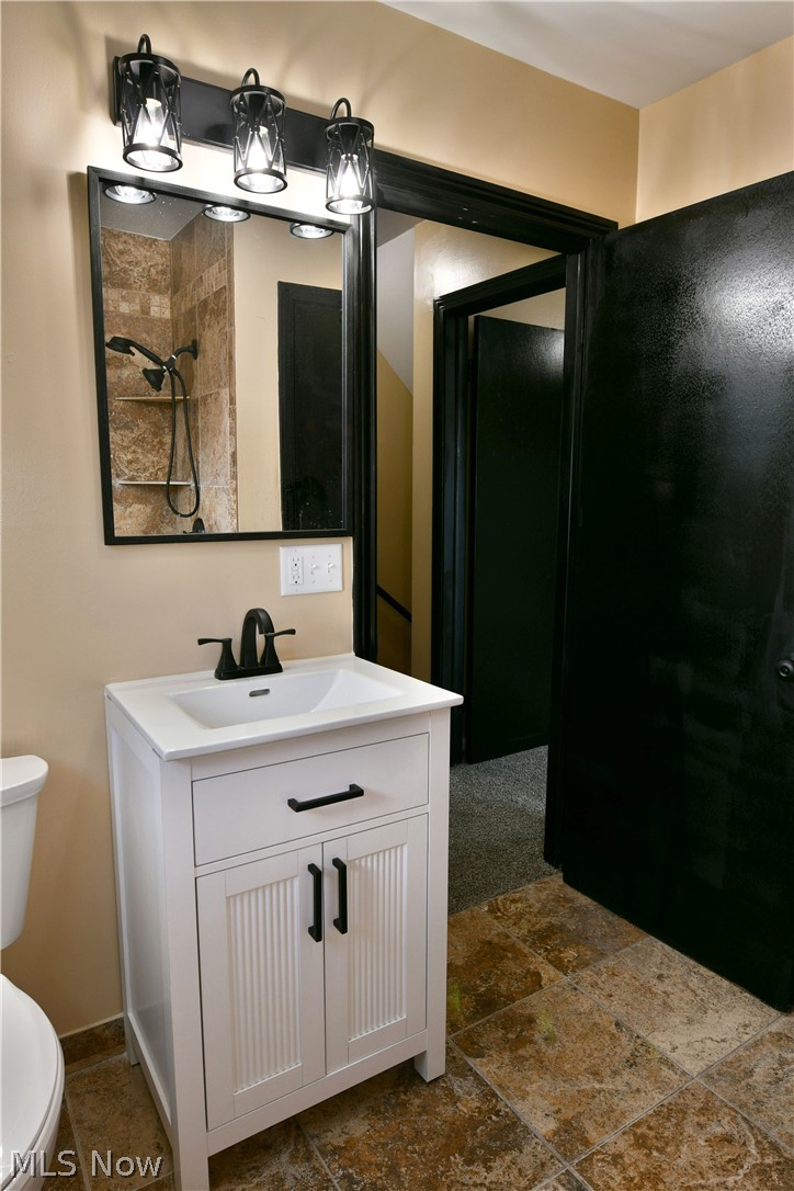 105 Fairview Avenue Cortland, OH 44410 - Photo 41 of 47 Bathroom featuring vanity, stone tile floors, and a shower