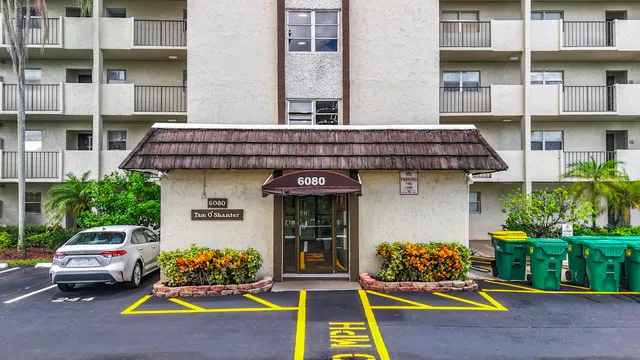 a bathroom with a granite countertop toilet sink and mirror