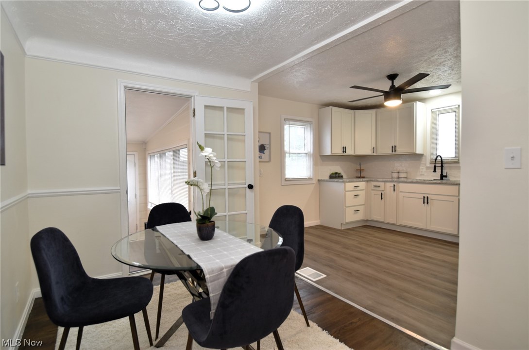 1259 Churchill Road Cleveland, OH 44124 - Photo 6 of 24 Wood floored dining room featuring a wealth of natural light, a textured ceiling, and ceiling fan
