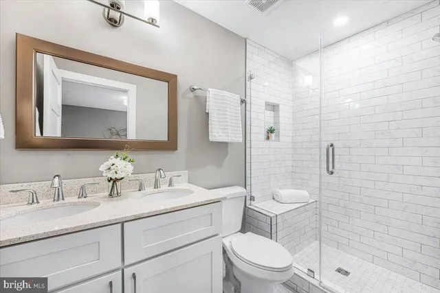 a bathroom with a toilet sink a mirror and