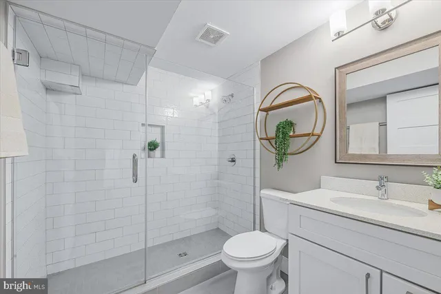 a bathroom with a sink and glass door