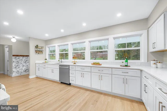 a large kitchen with stainless steel appliances granite countertop a stove and a sink
