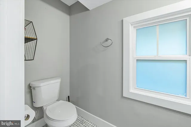 a white toilet sitting next to a white sink