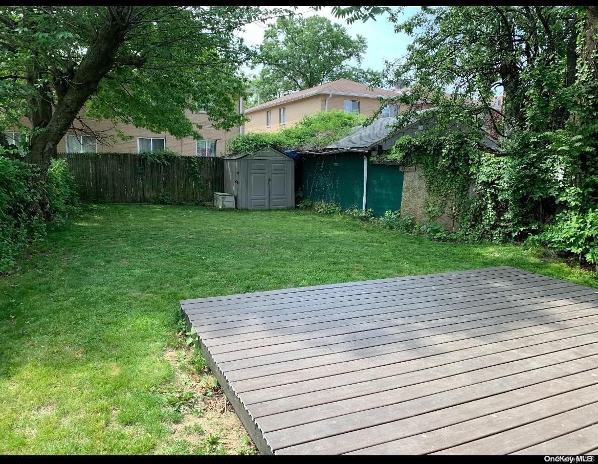 76-22 57th Road Queens, NY 11379 - Photo 2 of 9 a view of a backyard with a garden