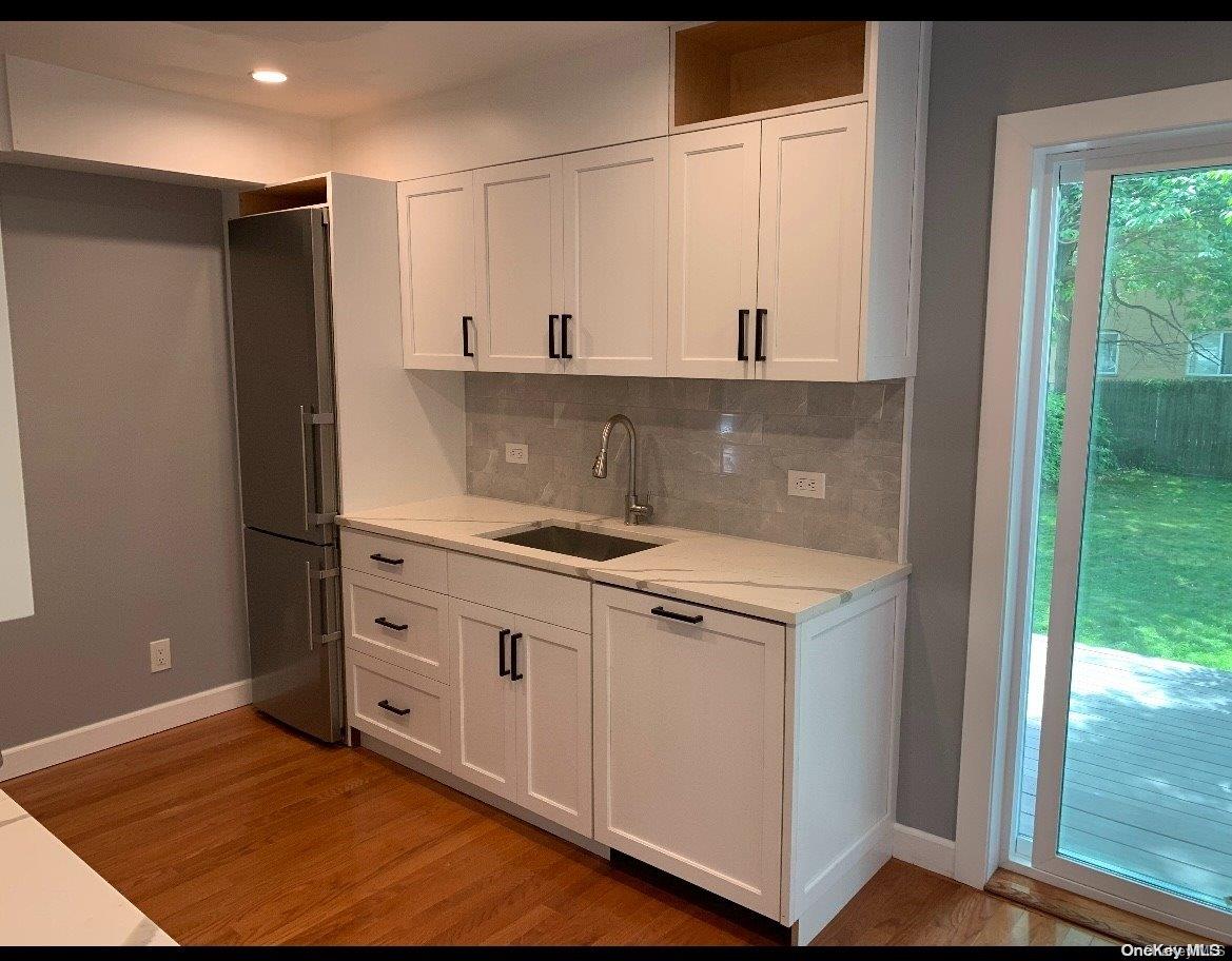 76-22 57th Road Queens, NY 11379 - Photo 3 of 9 a kitchen with a stove and a refrigerator
