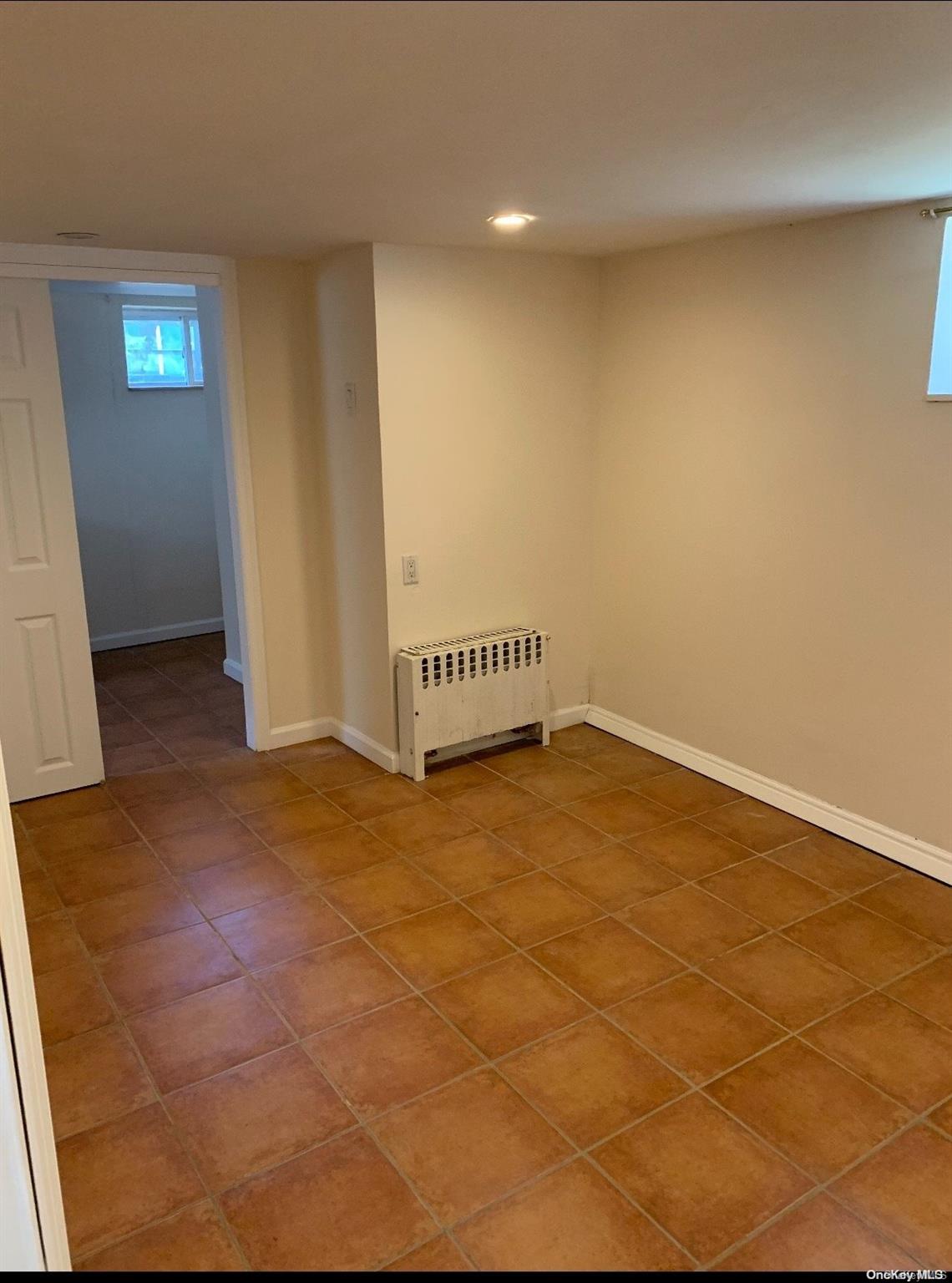 76-22 57th Road Queens, NY 11379 - Photo 8 of 9 a view of an empty room