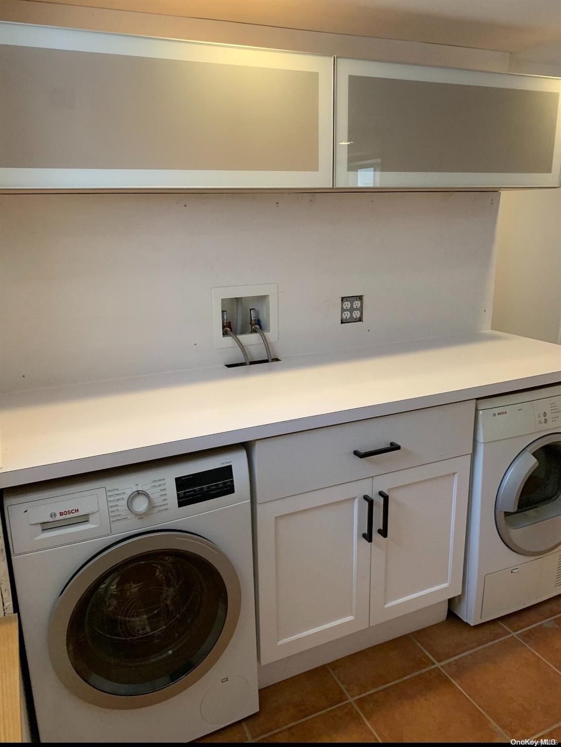 76-22 57th Road Queens, NY 11379 - Photo 9 of 9 a utility room with dryer and washer