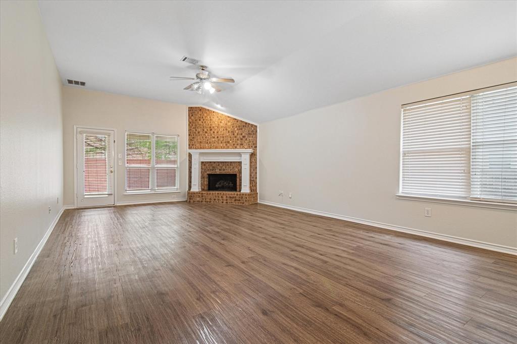 12072 Half Hitch Trail Frisco, TX 75035 - Photo 4 of 25 an empty room with wooden floor fireplace and windows