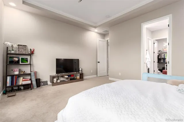 a bedroom with furniture and a flat screen tv