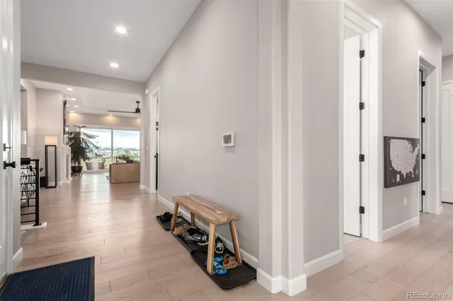 a view of a hallway with livingroom and furniture