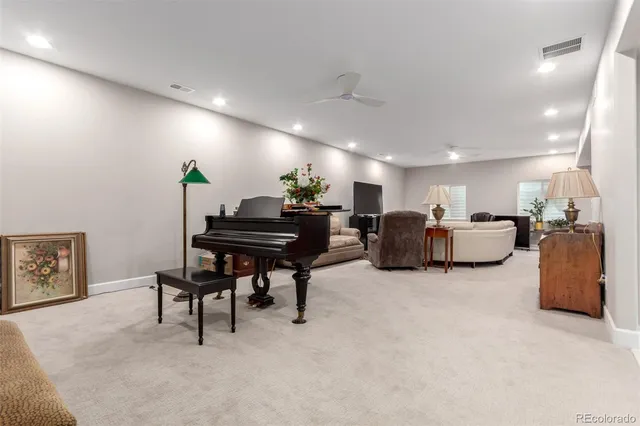 a living room with furniture and a piano