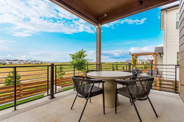 a balcony with table and chairs