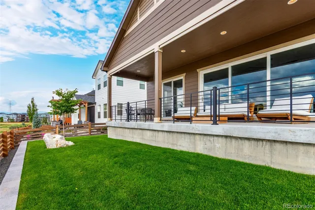 a swimming pool with outdoor seating and yard