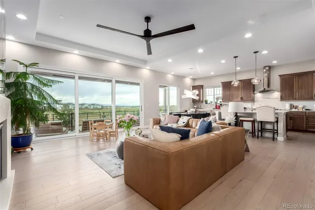 a living room with fireplace furniture and a large window