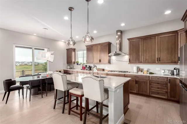 a large kitchen with a table and chairs