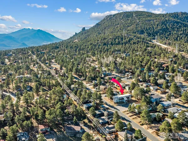 a living room with stainless steel appliances granite countertop furniture and a couch