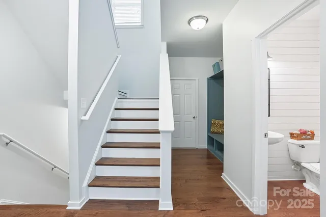 a view of a hallway with wooden floor and entryway