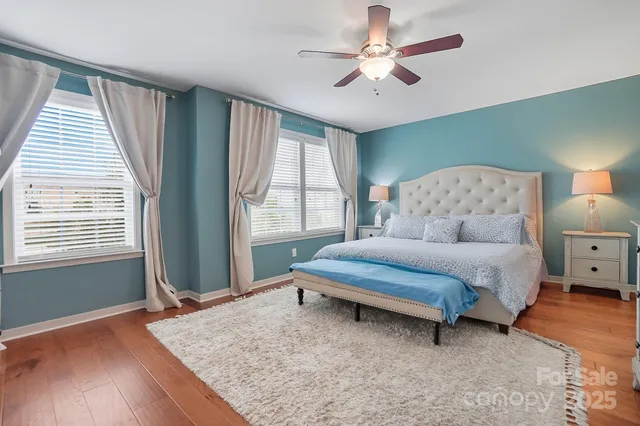 a spacious bedroom with a bed dresser and a window