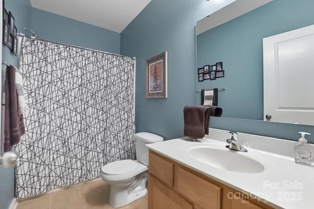 a view of a house with a yard and wooden fence