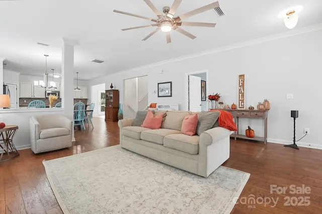 a living room with furniture and a chandelier