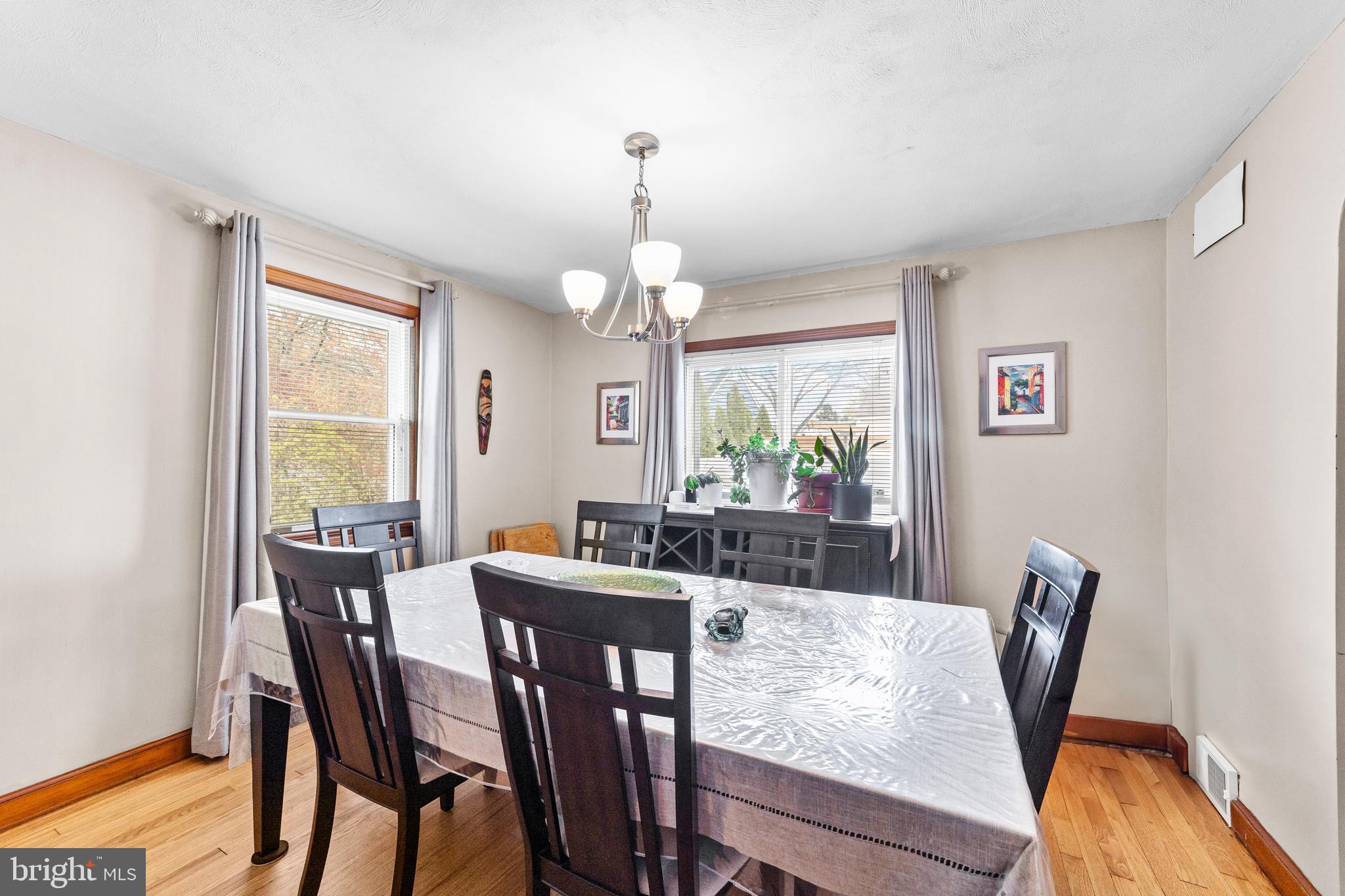 22 James Place Hamilton, NJ 08690 - Photo 12 of 23 a view of a dining room with furniture a chandelier and wooden floor