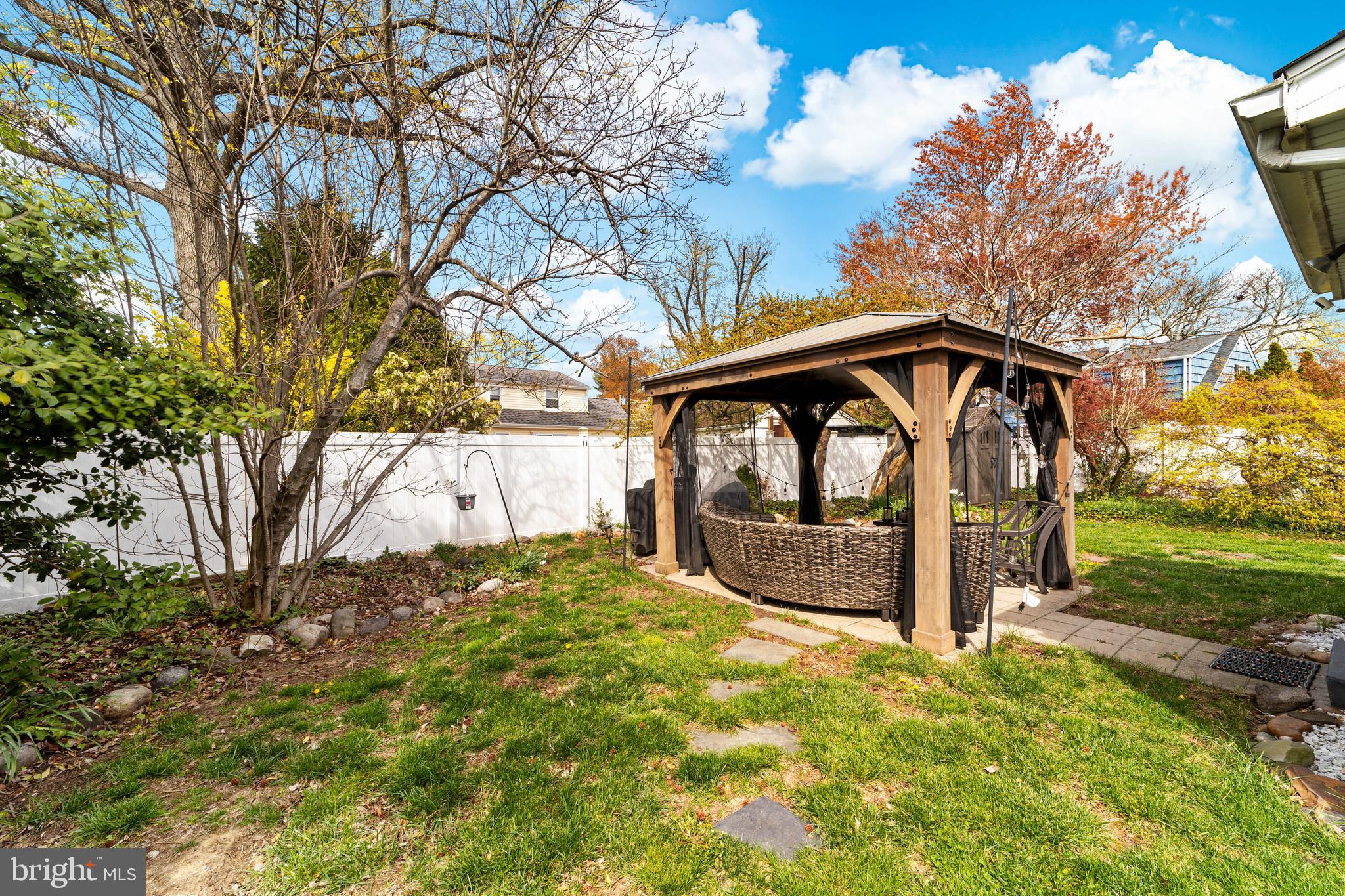 22 James Place Hamilton, NJ 08690 - Photo 23 of 23 a backyard of a house with a large tree and wooden fence