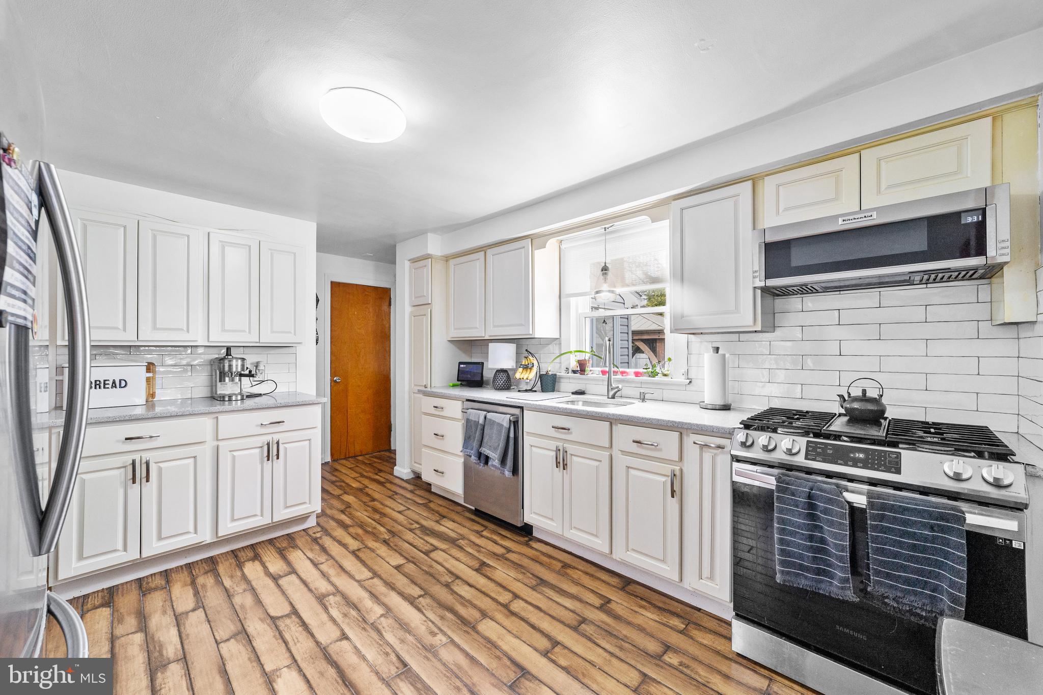 22 James Place Hamilton, NJ 08690 - Photo 9 of 23 a kitchen with stainless steel appliances a stove sink and cabinets