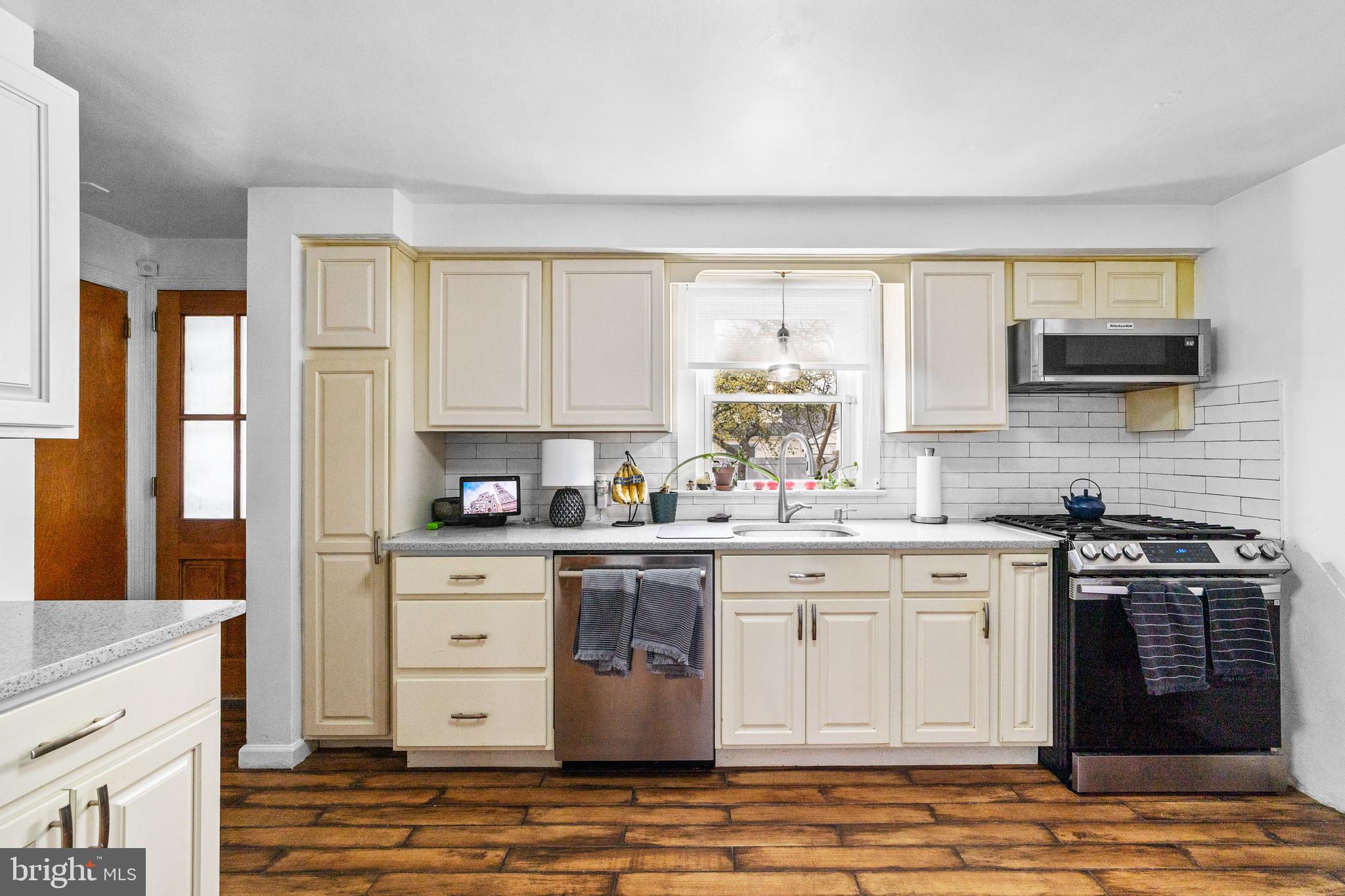 22 James Place Hamilton, NJ 08690 - Photo 10 of 23 a kitchen with stainless steel appliances granite countertop a stove a sink and a microwave