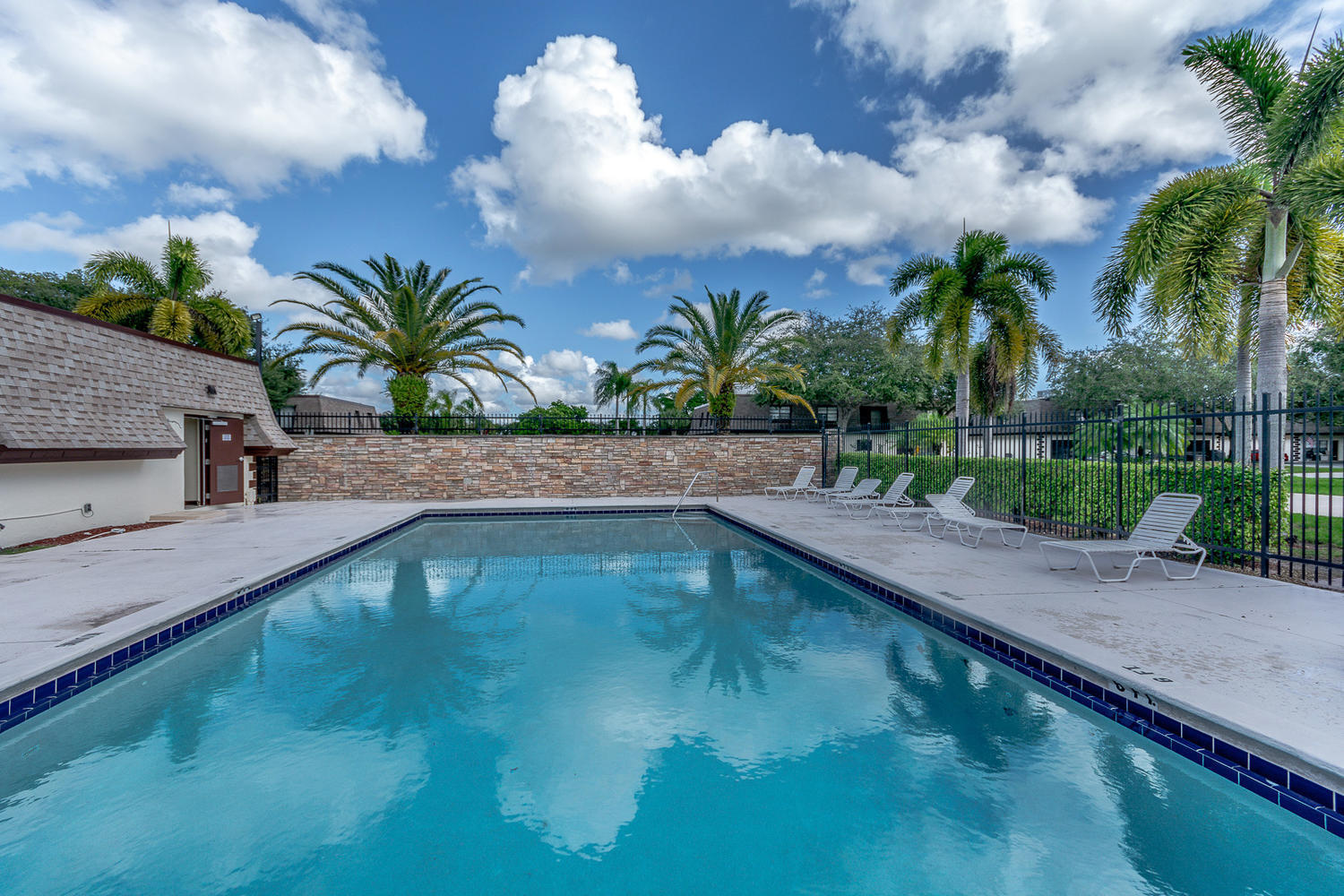 9370 Southwest 61st Way, Unit A Boca Raton, FL 33428 - Photo 7 of 19 a view of a swimming pool with a yard
