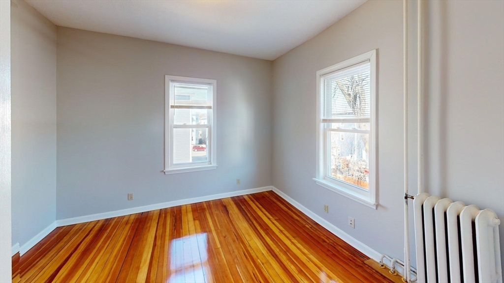 52 Sumner Street, Unit 3 Revere, MA 02151 - Photo 5 of 7 a view of a room with wooden floor and a window