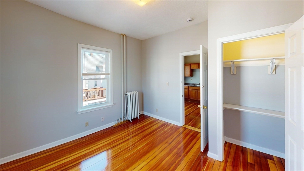 52 Sumner Street, Unit 3 Revere, MA 02151 - Photo 6 of 7 a bedroom with a bed and a window