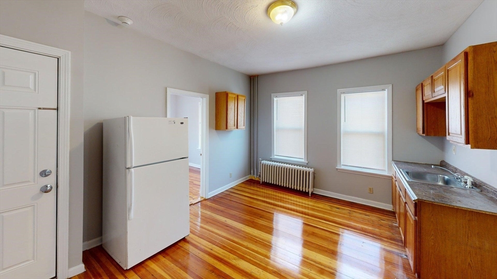 52 Sumner Street, Unit 3 Revere, MA 02151 - Photo 7 of 7 a kitchen with a refrigerator and a sink