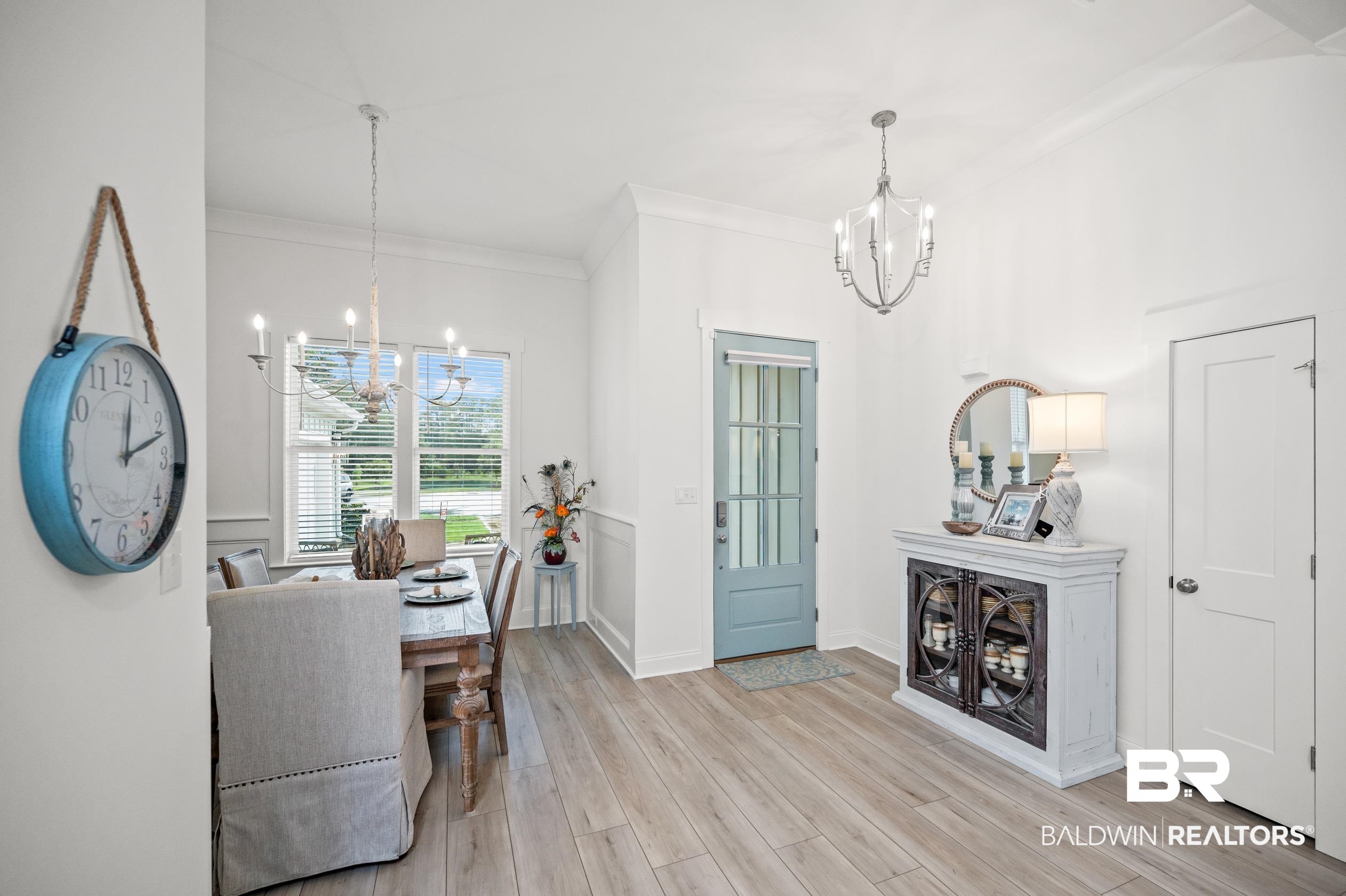 4601 Surrey Lane Orange Beach, AL 36561 - Photo 5 of 43 Entryway with crown molding, light hardwood / wood-style flooring, and an inviting chandelier