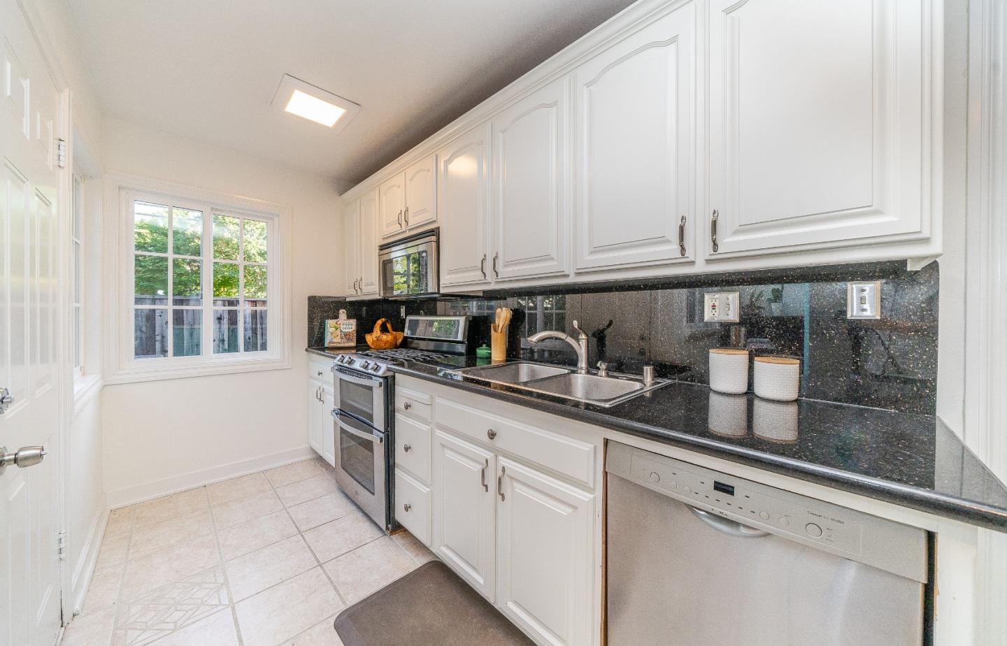 1896 Ellen Avenue San Jose, CA 95125 - Photo 17 of 50 a kitchen with stainless steel appliances granite countertop a sink and a white cabinets