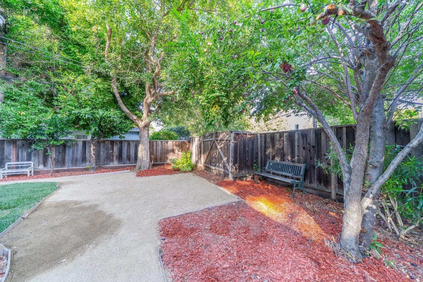 1896 Ellen Avenue San Jose, CA 95125 - Photo 35 of 50 a backyard of a house with table and chairs a barbeque and a large trees with a swing
