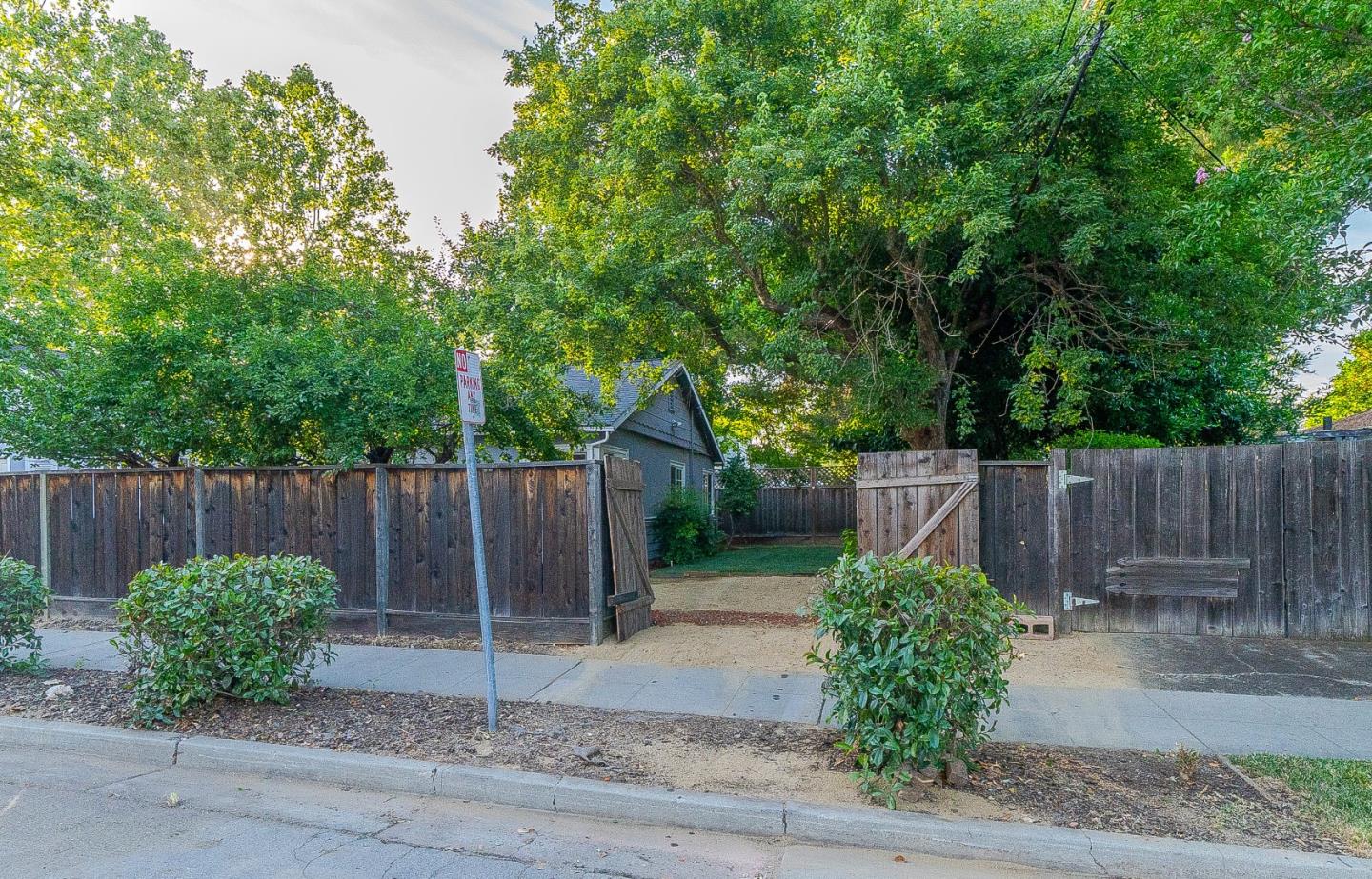 1896 Ellen Avenue San Jose, CA 95125 - Photo 41 of 50 a view of a backyard with potted plants a large tree and wooden fence