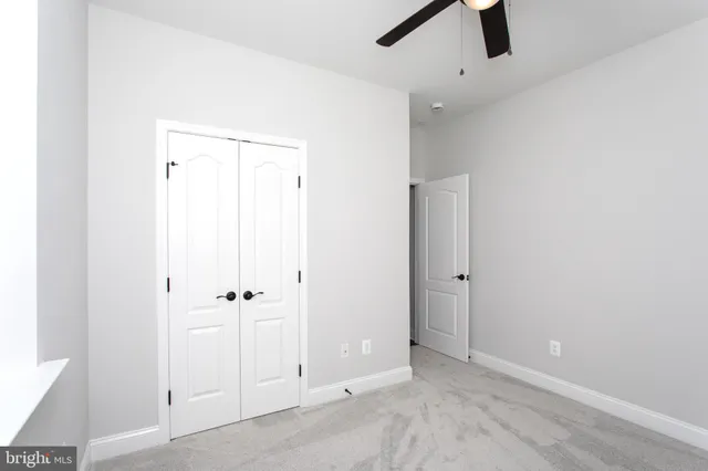 a view of an empty room with a chandelier