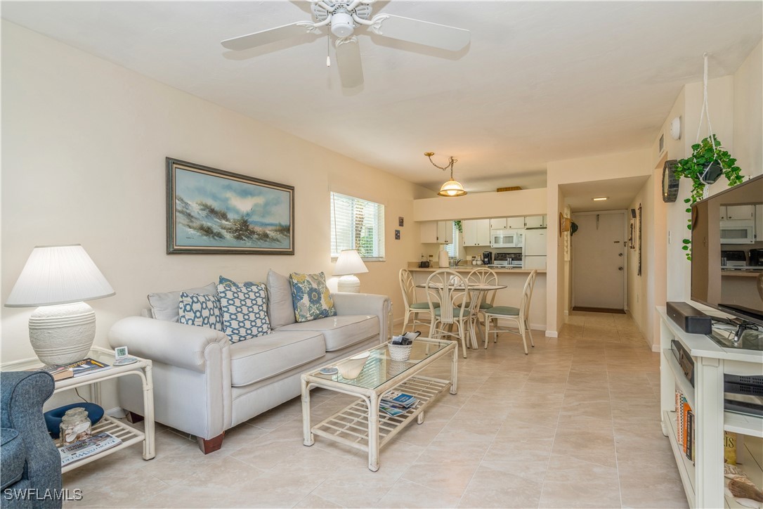 8049 Country Road, Unit 102 Fort Myers, FL 33919 - Photo 3 of 23 a living room with furniture and a view of kitchen
