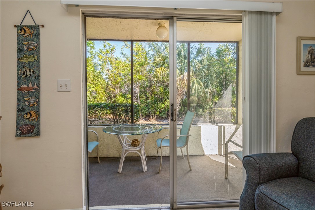 8049 Country Road, Unit 102 Fort Myers, FL 33919 - Photo 7 of 23 a dining room with furniture and a large window